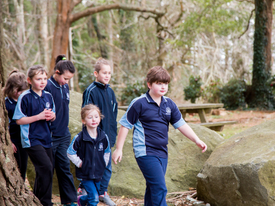 Students walking past rocks